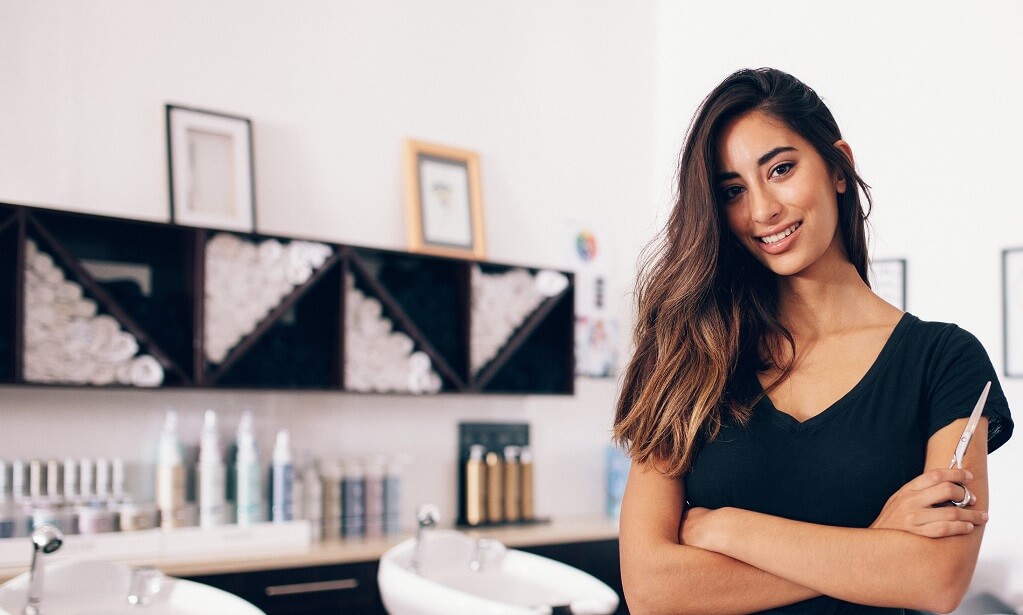 Hairdresser posing in front of shop