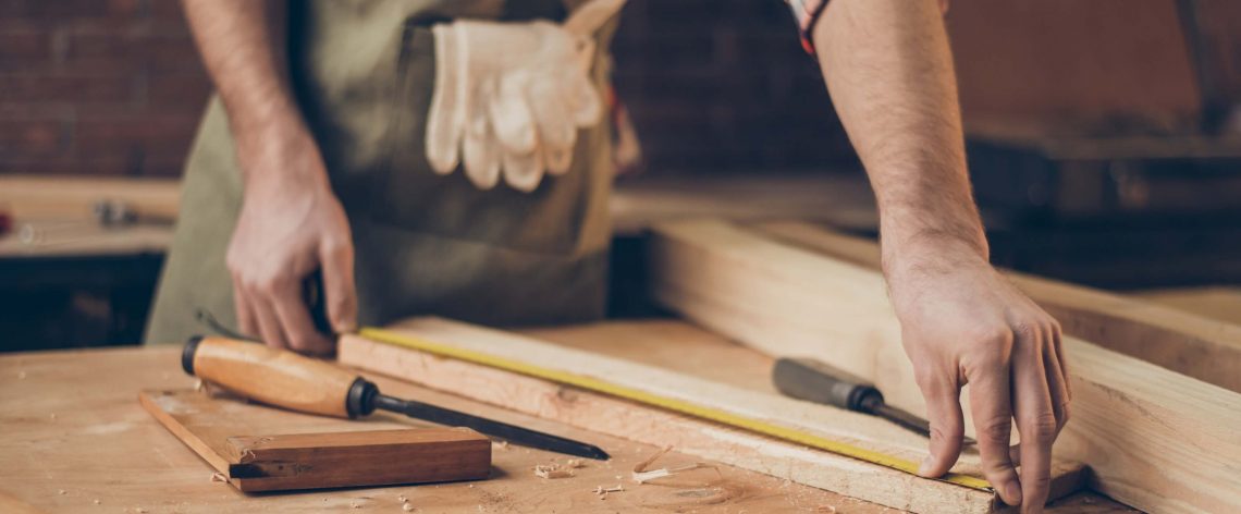 carpenter measuring a piece of wood