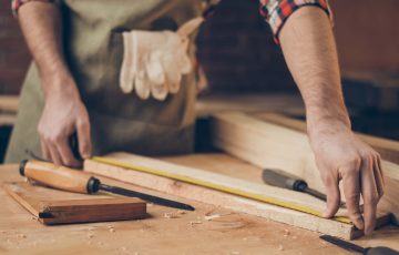 carpenter measuring a piece of wood