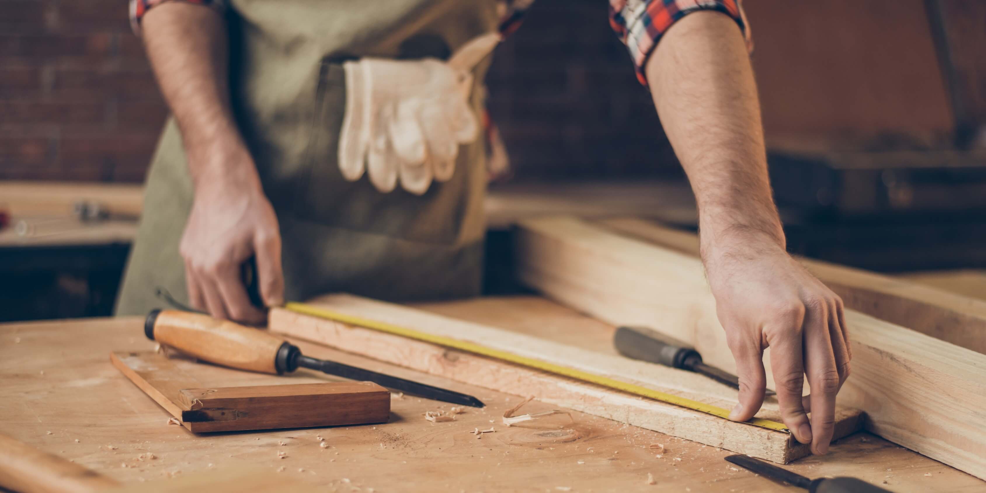 carpenter measuring a piece of wood