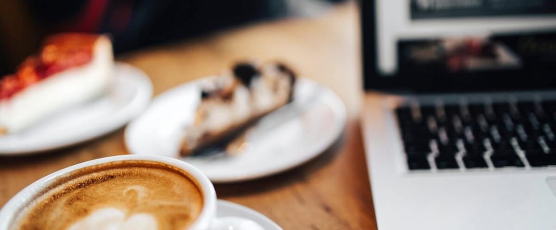 laptop, coffee and cake at a cafe