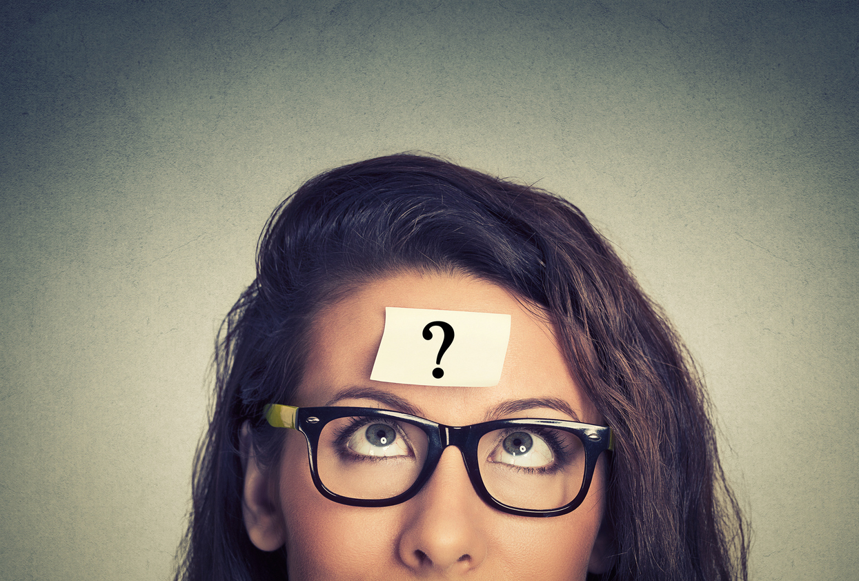 Woman with question mark sticky note on forehead