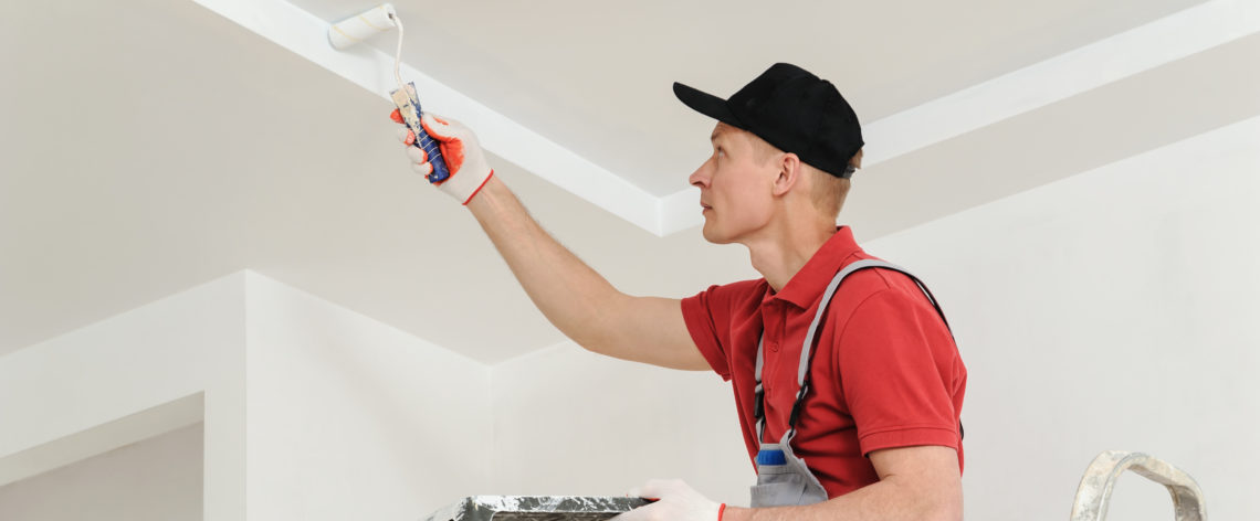 Painter painting a ceiling wall