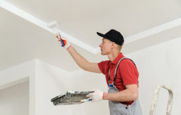 Painter painting a ceiling wall