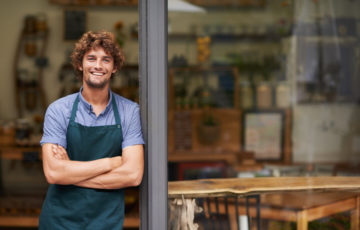 A cafe and restaurant owner outside his shop